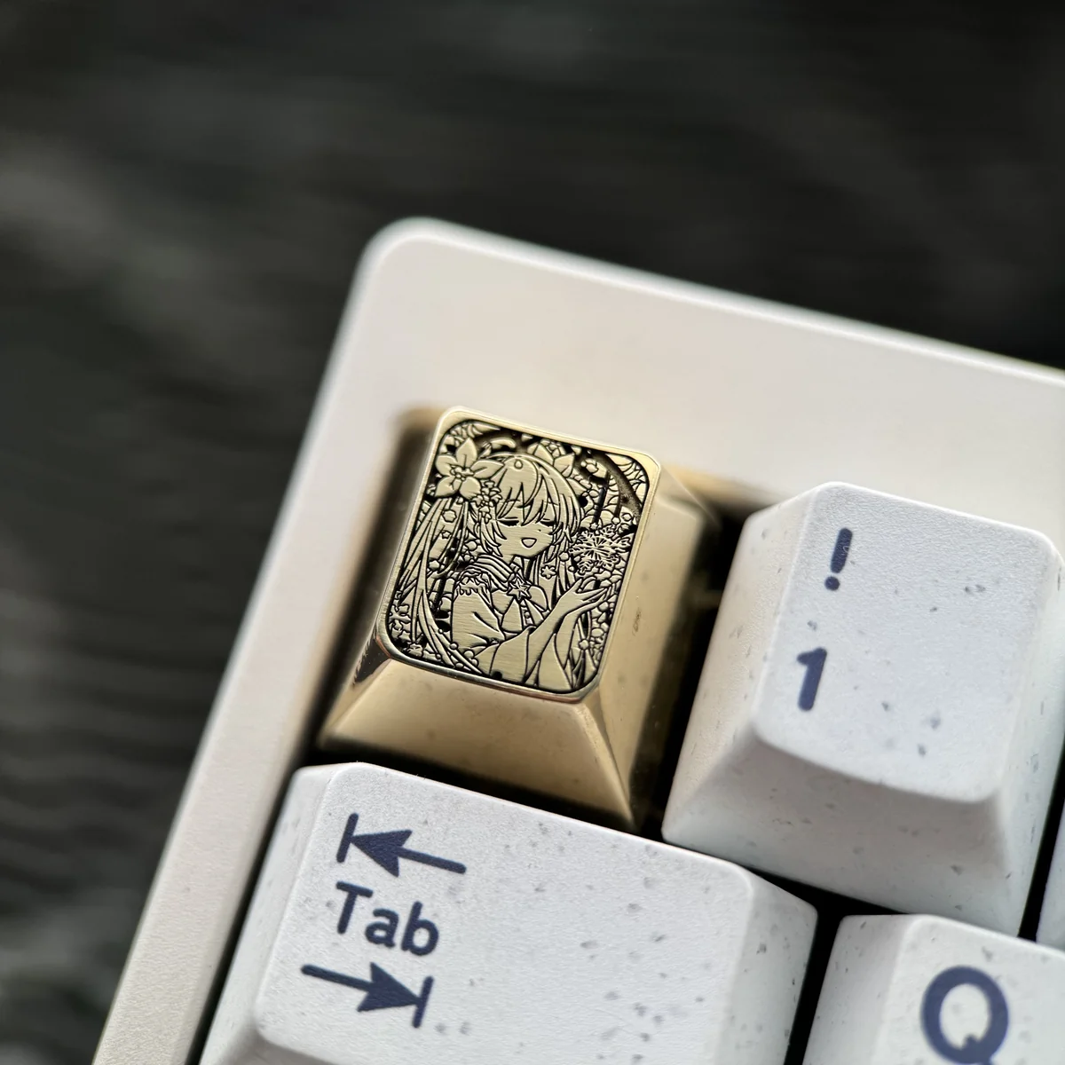 Close-up gallery views of the Hatsune Miku Brass Artisan Keycap, highlighting intricate engravings and polished Brass from various angles.