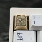 Close-up views of the premium Hatsune Miku Brass Artisan ESC Keycap, showcasing its intricately engraved design and polished brass from multiple.
