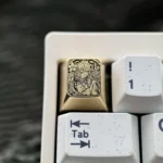 Detailed gallery views of the Hatsune Miku Brass Artisan ESC Keycap, showcasing its intricate character engraving and premium polished Brass finish.