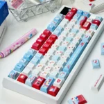 Iconic Hello Kitty Happy Travel PBT dye-sub keycaps set, shown from various angles, highlight their charming pastel colors and whimsical diary aesthetic.