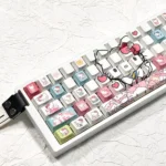 Angled view of iconic Hello Kitty PBT side-lit keycaps set, showcasing vibrant colors and crisp side-printed legends, perfect for RGB keyboards.