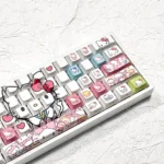 Playful Hello Kitty PBT side-lit keycaps set, shown from various angles. Highlights iconic designs, durable PBT, and clean side legends for vibrant RGB.