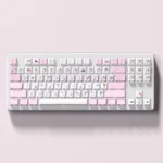 Playful close-up of durable pink PBT Hello Kitty side-lit keycaps set, showcasing the iconic character and vibrant legends from a unique angle.