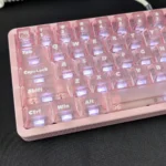 Detailed views of the playful Hello Kitty frosted pink backlit keycap set, showcasing its iconic face and soft, whimsical glow from various angles.