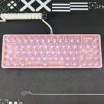 Close-up views of the whimsical Hello Kitty Frosted Pink Backlit Keycap set from various angles, highlighting its iconic design and soft, translucent glow.