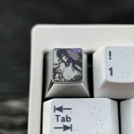 A close-up of the premium Honkai Star Rail Herta titanium artisan keycap, featuring intricate precision-colored details and a striking metallic sheen.