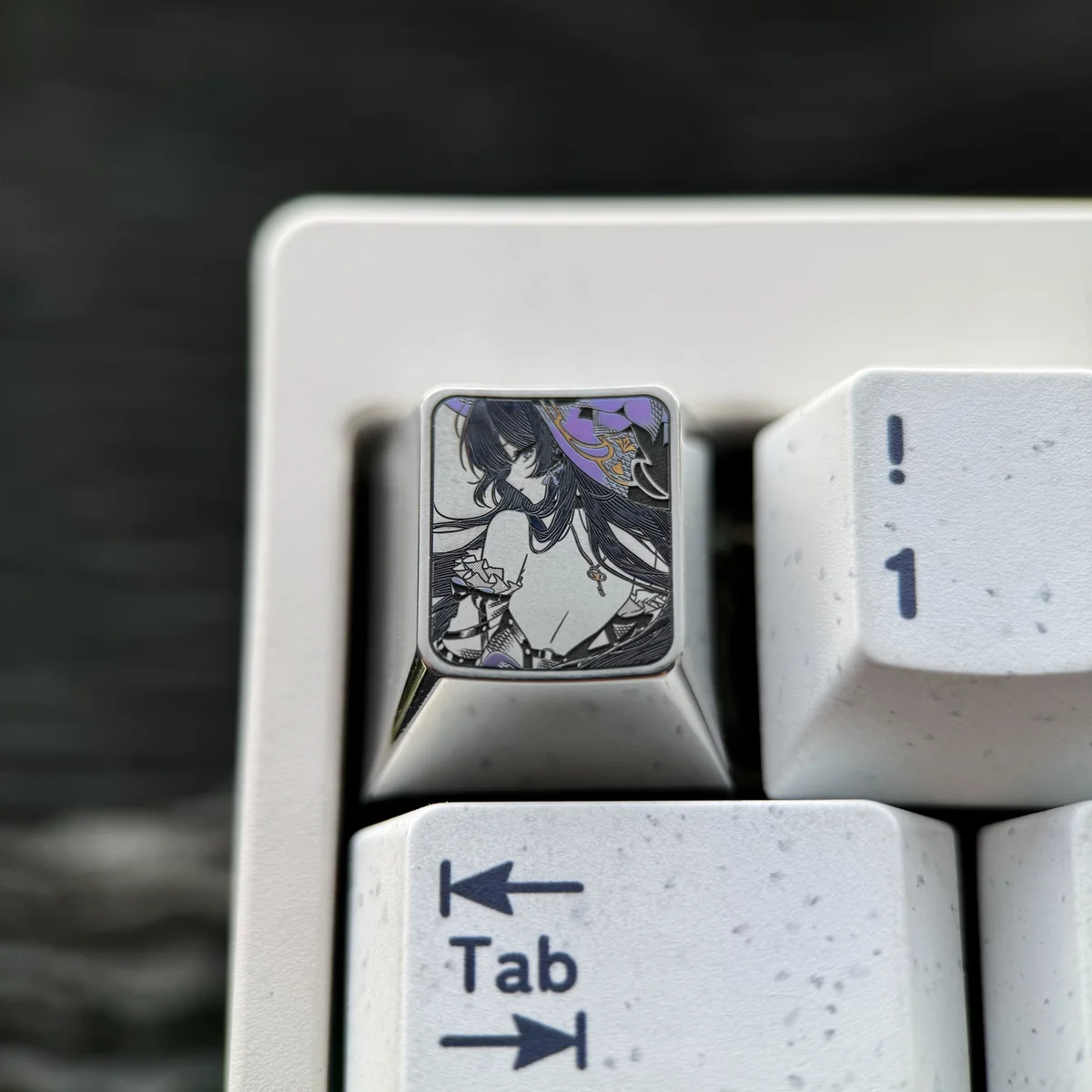 A close-up of the premium Honkai Star Rail Herta titanium artisan keycap, featuring intricate precision-colored details and a striking metallic sheen.