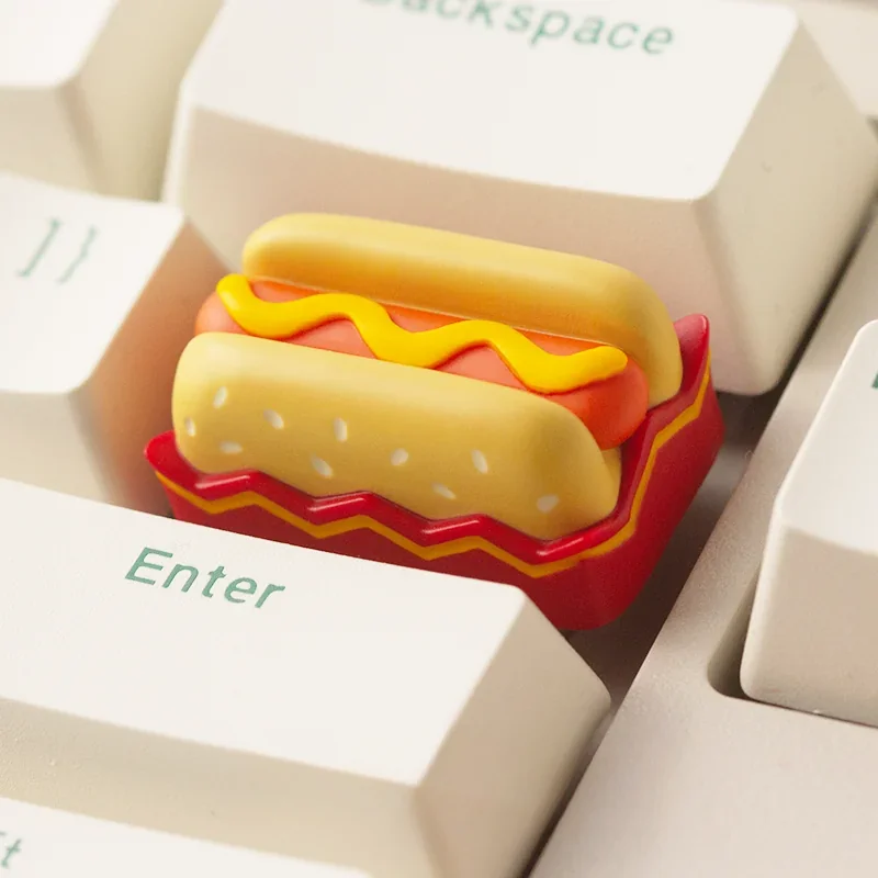 A charming handcrafted hotdog artisan keycap made of detailed resin, showcasing whimsical miniature food art, perfectly fits an ESC key.