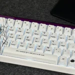 Artistic gallery of Isabelle Keycaps Set, showcasing the elegant side-printed RGB PBT set from various angles. Features unique original character art.