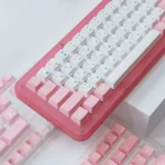A detailed view of elegant Sakura PBT dye-sublimated keycaps set, highlighting the delicate pink and white cherry blossom design. Durable and premium set.