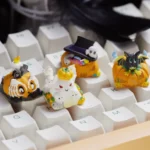 Detailed gallery views of a handcrafted luminous resin Halloween ESC keycap, revealing its charming, glowing pumpkin design from various artistic angles.