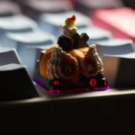 Handcrafted luminous resin Halloween ESC keycap, featuring a charming, detailed pumpkin design glowing translucently, shown from various angles.