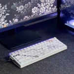 A close-up of the premium PBT marble keycap set, showcasing its exquisite side-engraved legends and subtle backlighting from a unique perspective.