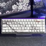 Elegant marble keycap set featuring side-engraved legends and subtle PBT backlighting, showcasing a natural stone texture for a premium keyboard aesthetics.