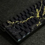 Gallery of premium Black Gold Marble PBT keycaps set, highlighting their sleek side-engraved legends and natural stone aesthetic from multiple perspective angles.