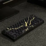 Close-up views of luxurious black gold marble PBT keycaps set, showcasing their elegant side-engraved legends and natural stone aesthetic from multiple angles.