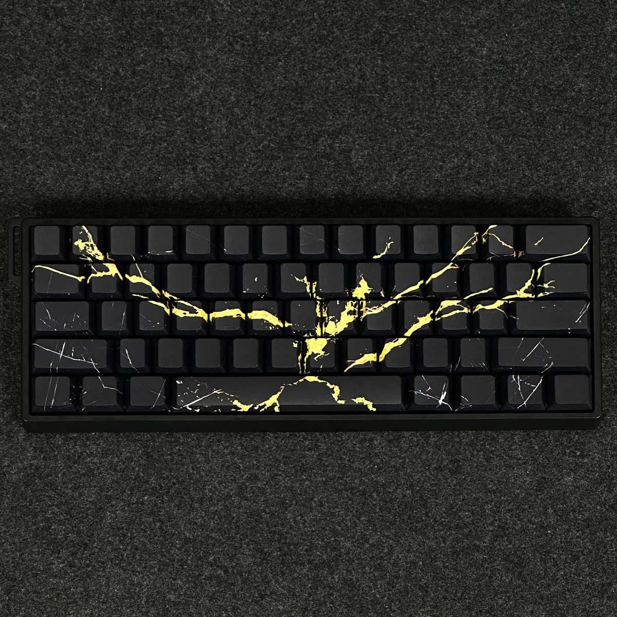 Elegant Black Gold Marble PBT keycaps set, showcasing luxurious side-engraved legends and a premium stone aesthetic.