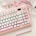Sweet Meiji Strawberry PBT keycaps set, photographed from various angles, highlighting their charming pink and white snack-inspired design.
