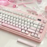 Sweet pink Meiji Strawberry PBT keycaps set displayed from multiple angles, showcasing the charming snack-inspired design.