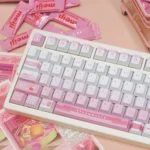 A playful new angle of the Meiji Strawberry PBT keycaps set, showcasing their charming pink and white snack-inspired design.