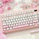 Sweet Meiji Strawberry Keycaps Set, a delightful pink and white PBT set, beautifully displayed with a playful charm.