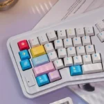 Vibrant Memphis Keycaps Set showcasing bold geometric shapes and contrasting colors from multiple angles, highlighting their playful retro-futurist desk setup.