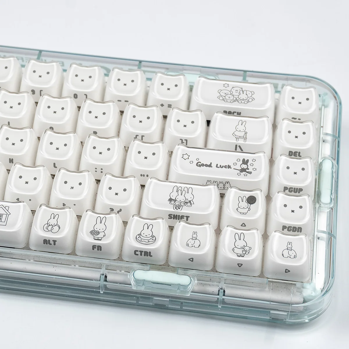 Miffy crystal jelly MAO keycaps set from various angles, showcasing their translucent pastel pink and white glow with side-engraved Miffy details.