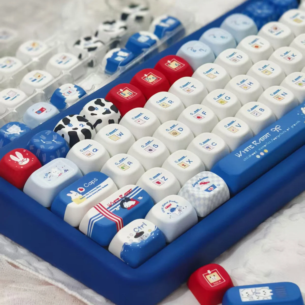 Milk Rabbit Keycaps set, angles shown. Adorable pastel pink and cream PBT dye-sub designs with whimsical candy and rabbit motifs, capturing sweet Shanghai charm design.