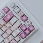 Multiple angles of premium Monster Hunter PBT keycaps set, showcasing vibrant dye-sublimated iconic creatures, weapons, and symbols for an immersive gaming setup.