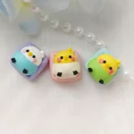 Vibrant, whimsical handcrafted parakeet resin keycap, showcasing an intricately layered miniature parakeet design, a unique and adorable keyboard accessories.