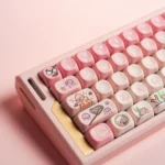 Close-up of whimsical pink Patrick Star PBT MOA keycaps set from multiple angles, showcasing the dye-sublimated cartoon designs and ergonomic profile.