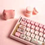 Patrick Star PBT MOA keycap set. Vibrant pink dye-sublimated keys with iconic designs are shown from multiple angles, highlighting the ergonomic profie.