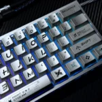 Close-up views of the iconic Printstream keycaps set, showcasing their dynamic graffiti design with a striking contrast of metallic sheen and smooth design.