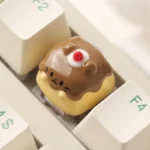 Handcrafted Pudding Cat Keycap, a whimsical resin artisan ESC keycap. Adorable 3D feline design with translucent layered resin, showcasing unique artisan.