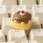Handcrafted Pudding Cat Keycap made of translucent resin, showcasing a whimsical 3D feline design. This unique artisan ESC keycap adds playful charm.