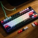 Detailed shot of the Red Vortex PBT dye-sub keycaps set, highlighting the dynamic red and black swirling patterns and futuristic cosmic storm design.