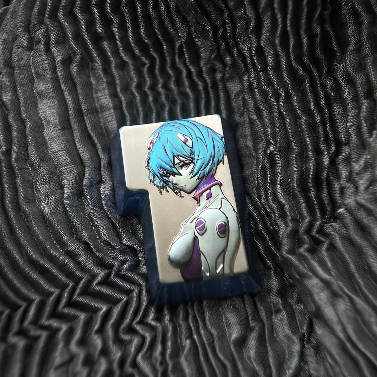 Iconic Rei Ayanami Titanium 3D artisan Enter keycap, showcasing intricate relief sculpture with a metallic finish. A premium collector's piece.