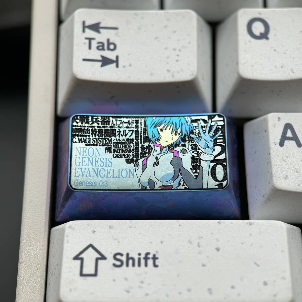Detailed views of the premium Titanium Rei Ayanami artisan keycap from various angles, showcasing its sleek metallic finish and iconic anime art.