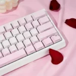 A collection of Rose Coast Luminous Side-Engraved PBT Keycaps, showcasing their serene pink, orange, and grey gradients from multiple artistic angles.
