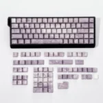 A serene grey Rose Coast PBT keycap set, featuring luminous side-engraved legends evoking tranquil coastal artistry.