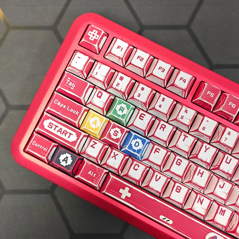 Vibrant Super Mario Family Computer PBT dye-sub keycaps set featuring iconic 8-bit characters and Famicom designs, displayed from a dynamic angle to highlight the design.