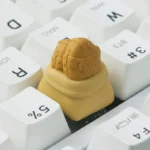 Handcrafted resin Taiyaki artisan ESC keycap, a whimsical golden-brown miniature culinary art piece with detailed finish.