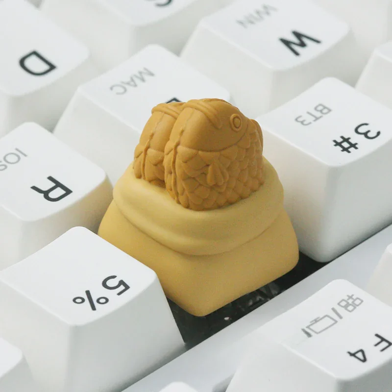 Handcrafted resin Taiyaki artisan ESC keycap, a whimsical golden-brown miniature culinary art piece with detailed finish.