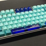 Vibrant transparent blue PC Supplement Keycap Set with an ethereal Dawn gradient, enhancing custom keyboards with artistic, luminous aesthetics.