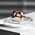 Handcrafted Venom keycap displayed from various angles, revealing its powerful alloy design encased in transparent resin, embodying a dark, artistic angles.