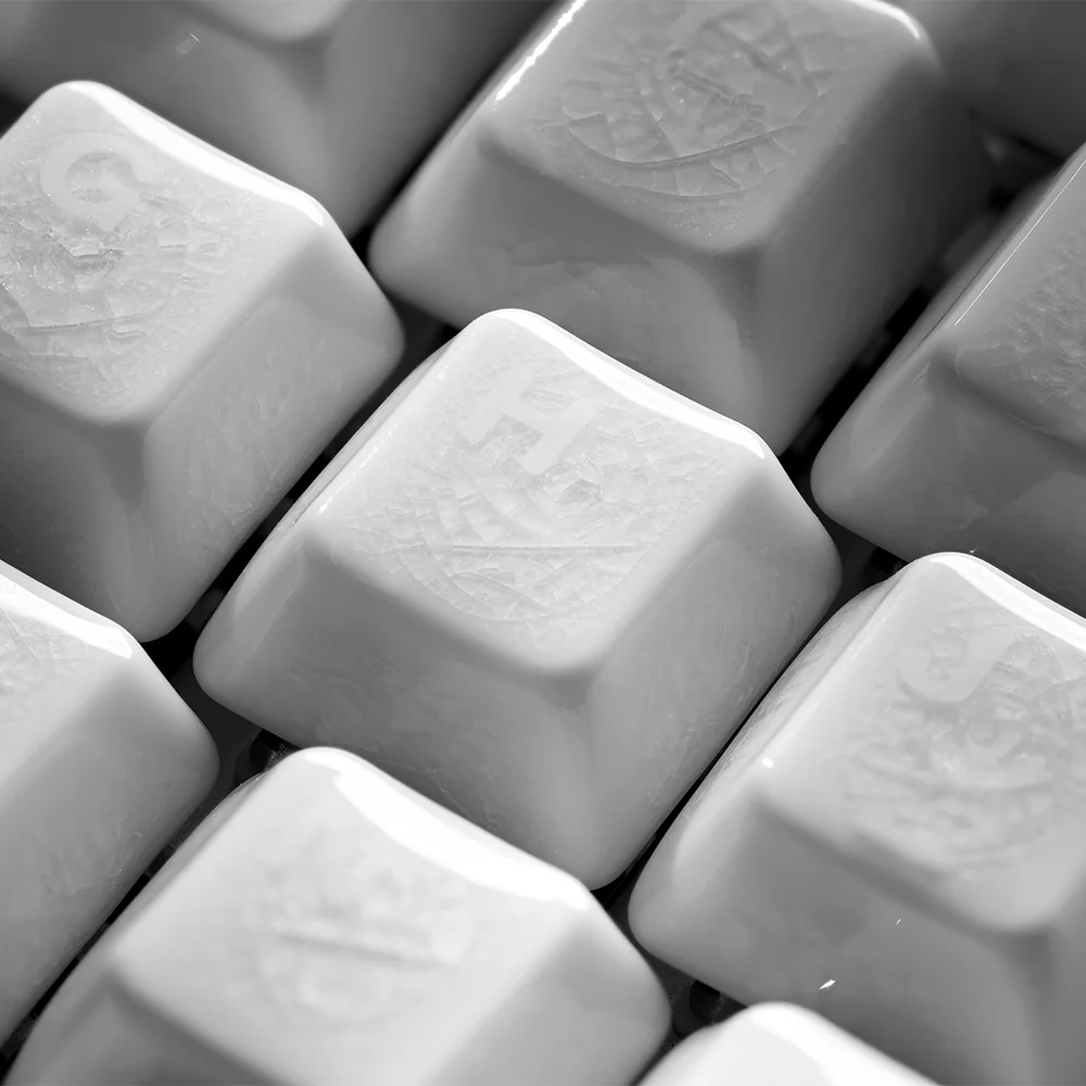 A gallery of handcrafted ice crack ceramic keycaps set, each revealing its unique natural crackle texture and translucent white elegance from diverse perspective.
