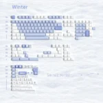 Multiple angles of Winter Serenity PBT keycaps set, showcasing the durable PBT, Cherry profile, and serene frosty blue, white, gray winter aesthetic.