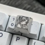 Vibrant, precision-engraved Wuthering Waves Carlotta titanium keycap showcasing intricate character art on a reflective surface.