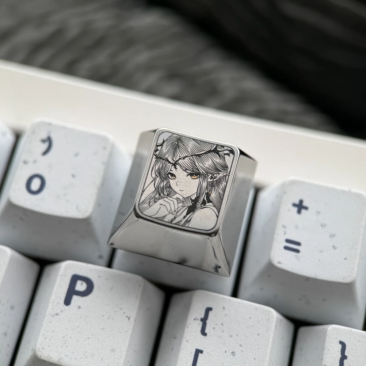 A stunning Cartethyia Wuthering Waves keycap, precision-engraved with vibrant character art on polished titanium, showcasing its premium artisan quality.