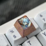 Premium Wuthering Waves Camellya titanium artisan keycap showcasing intricate metallic design, luster, and detailed craftsmanship from multiple angles.